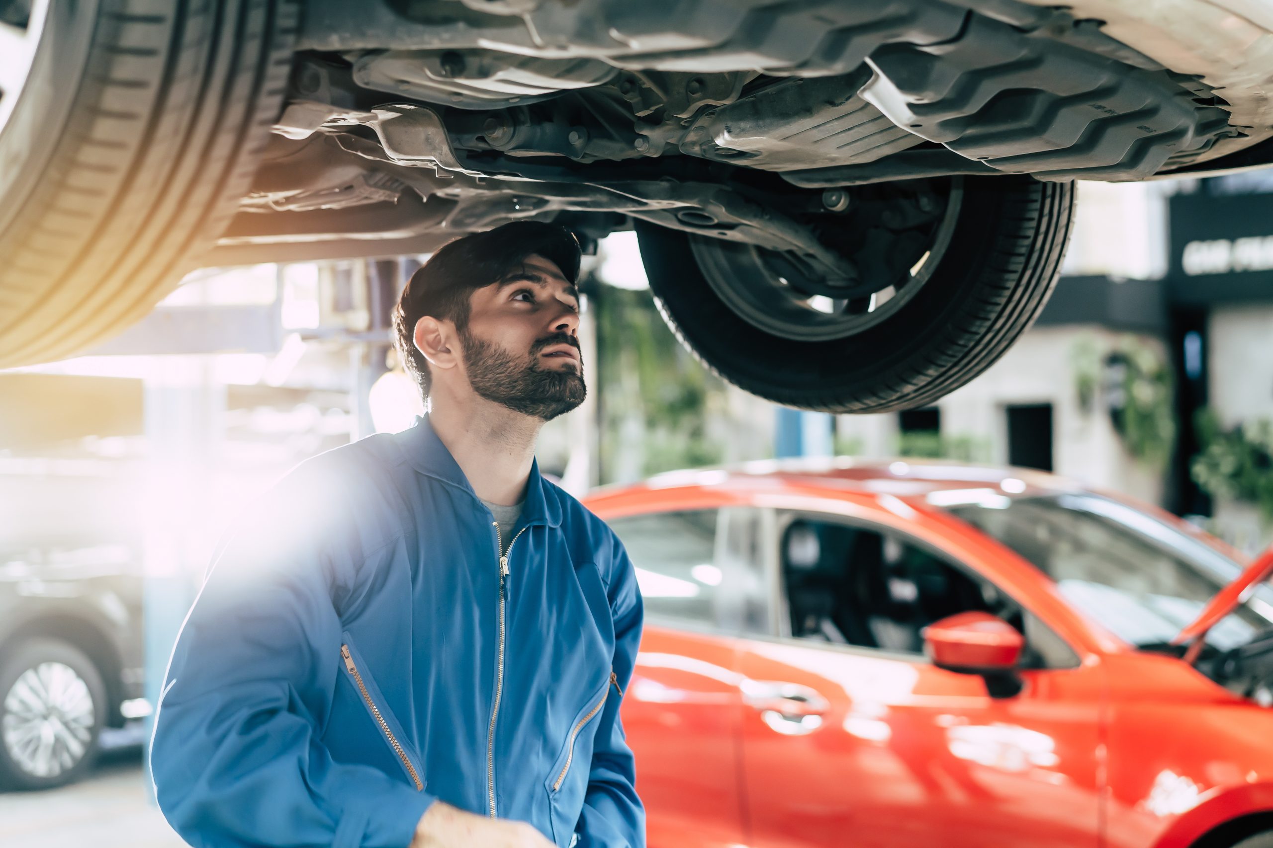 Man performing an MOT in a blue jumpsuit