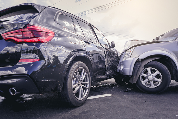 A side on car crash between a black SUV and a small silver car