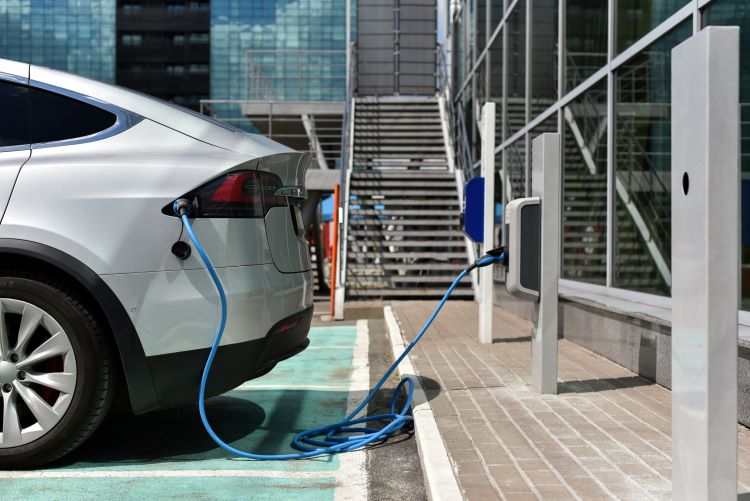 White electric car charging at an office