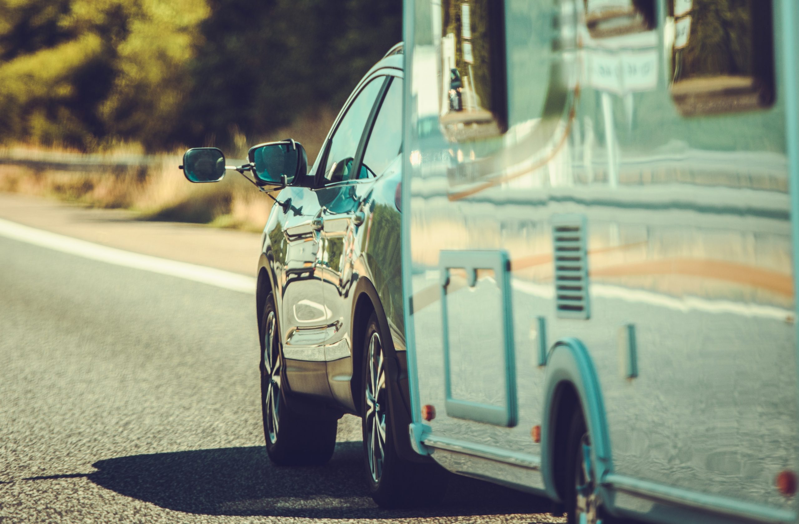 A Car Pulling A Recreational Vehicle.