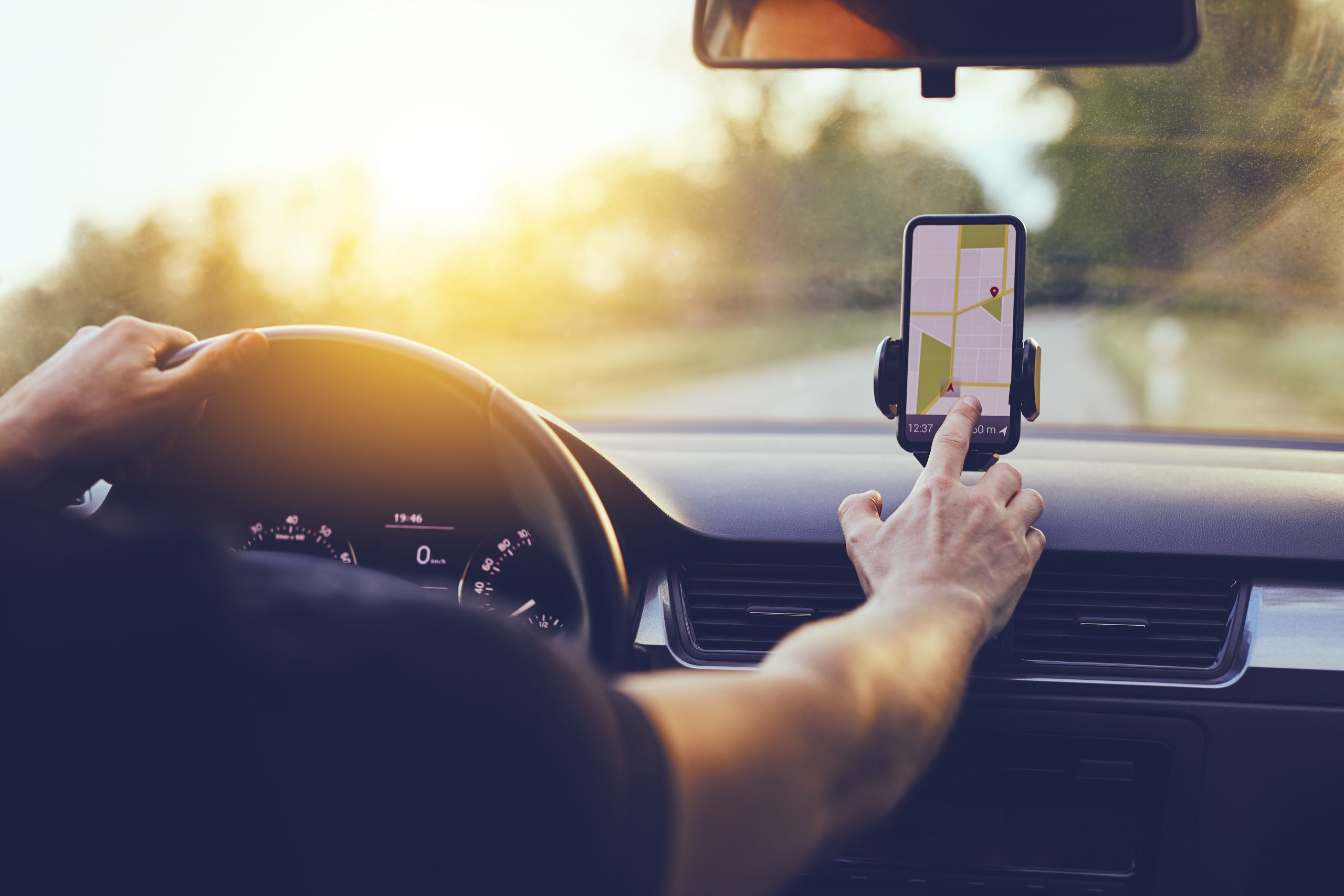 Driver using GPS navigation in mobile phone whilst driving a car