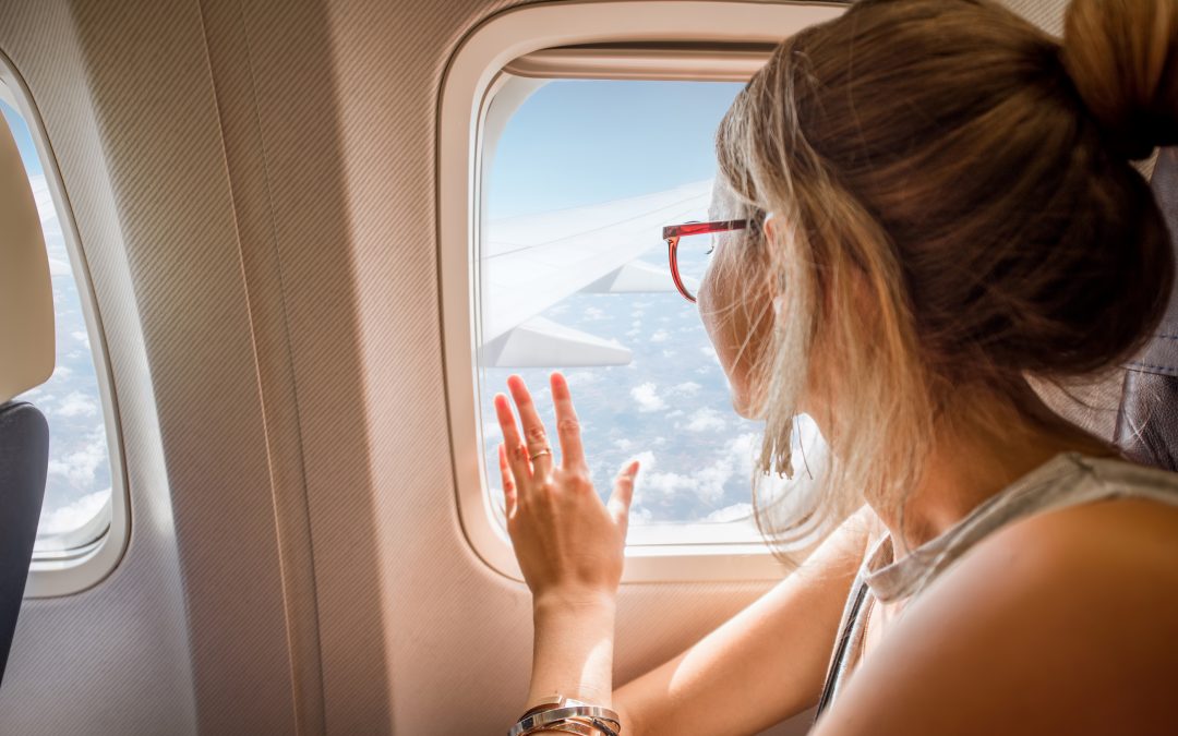 Woman looking out of a plane window