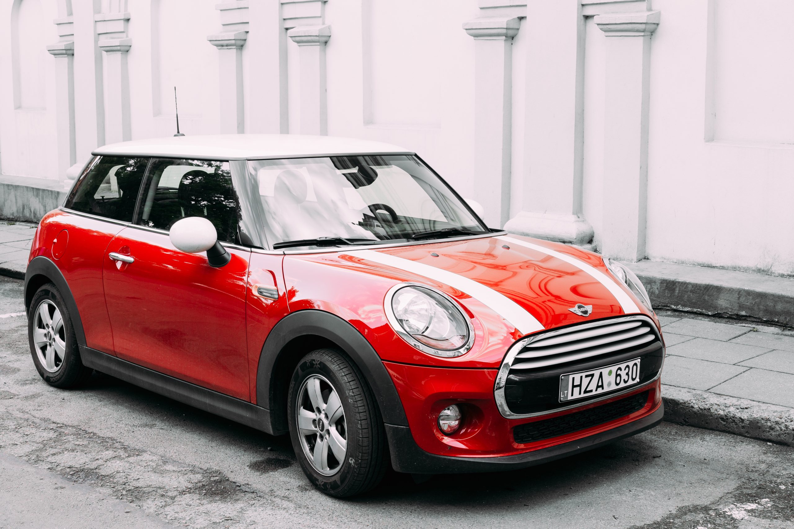 Red Color Car With White Stripes Mini Cooper Parked On Street In