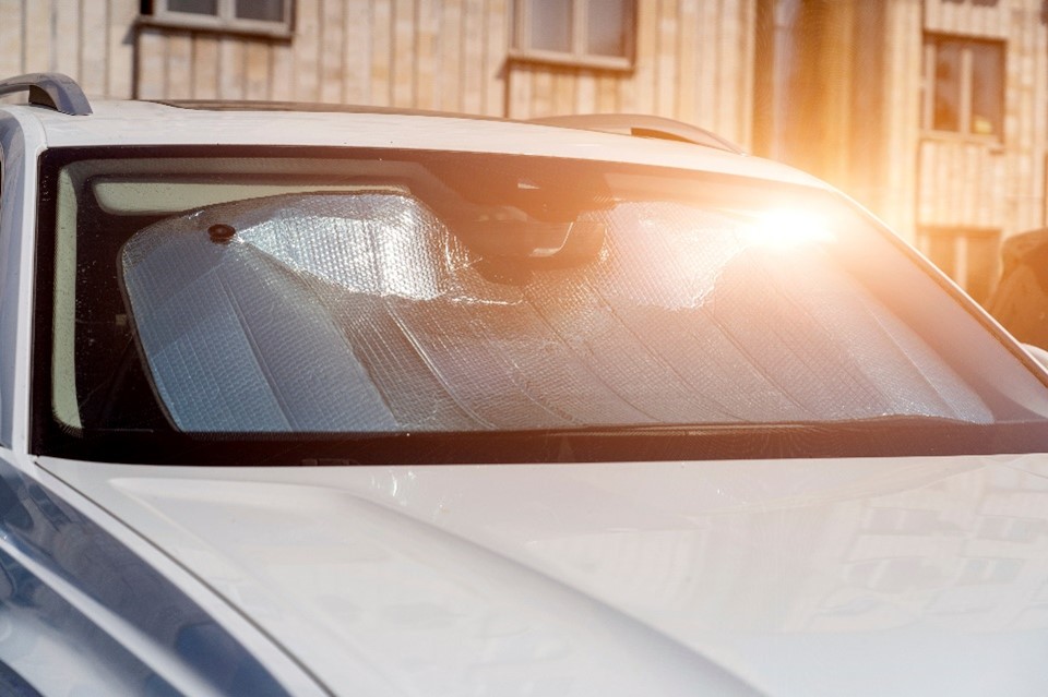 Car windscreen sun protector in a car in the sun