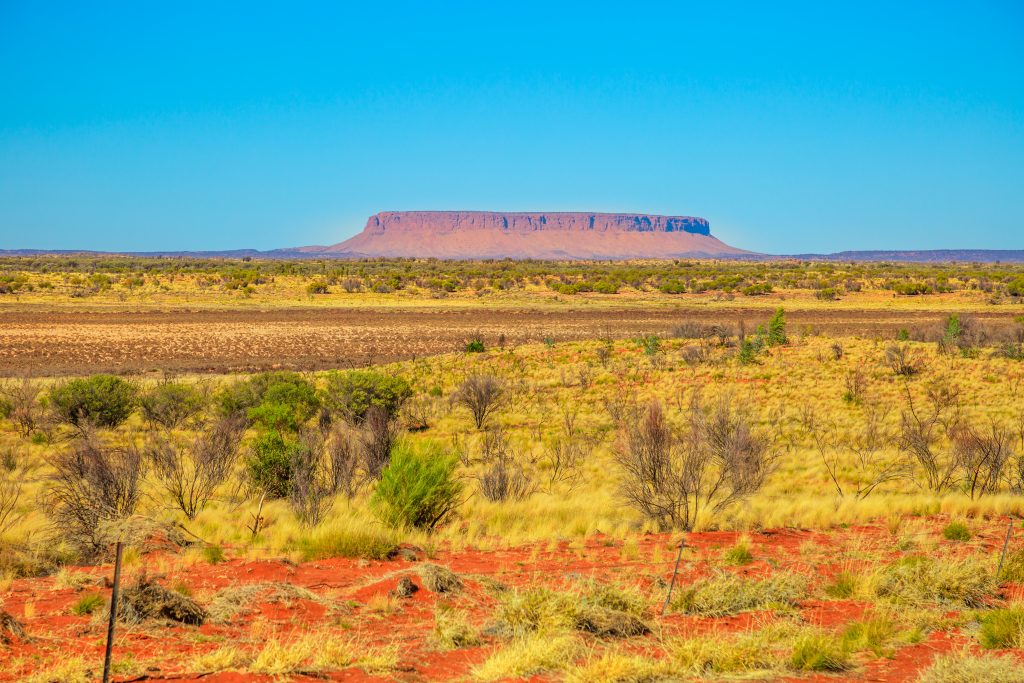 Iconic table mountain or Mount Conner often mistaken for Uluru. It is located near Kings Canyon Watarrka National Park. Red desert landscape in Australia Outback Red Center, Northern Territory.