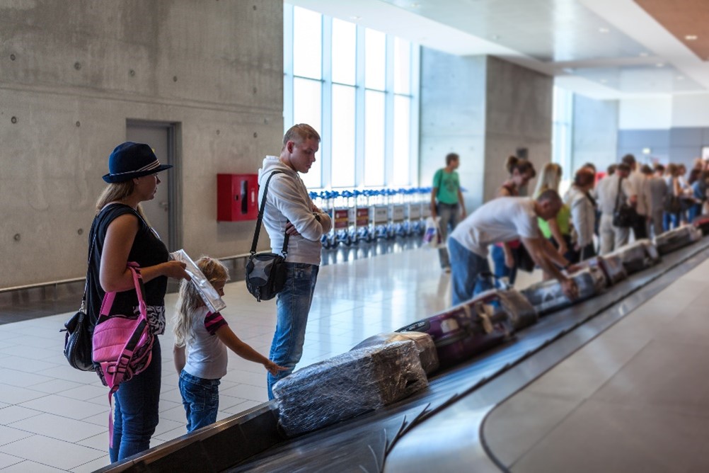 People waiting to collect their bags at baggage reclaim at the airport