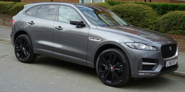 Gray Jaguar i-Pace parked on side of a road in a residential area