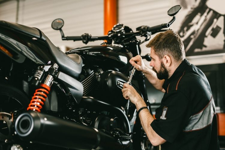 Mechanic Servicing Motorbike