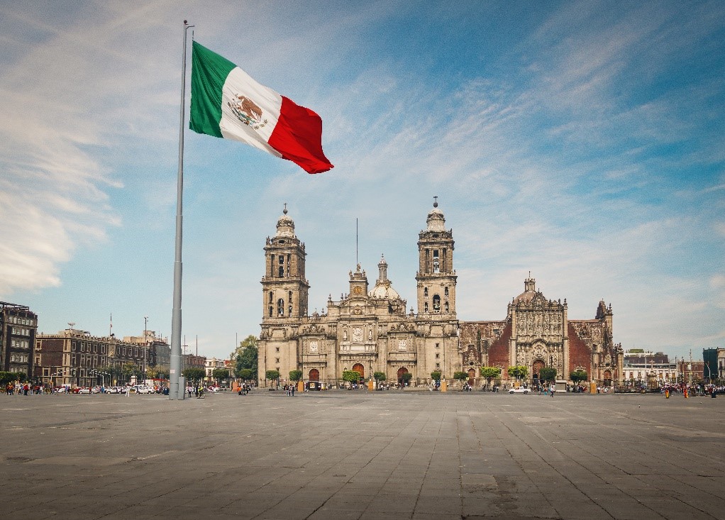Mexican flag in front of a historical building 