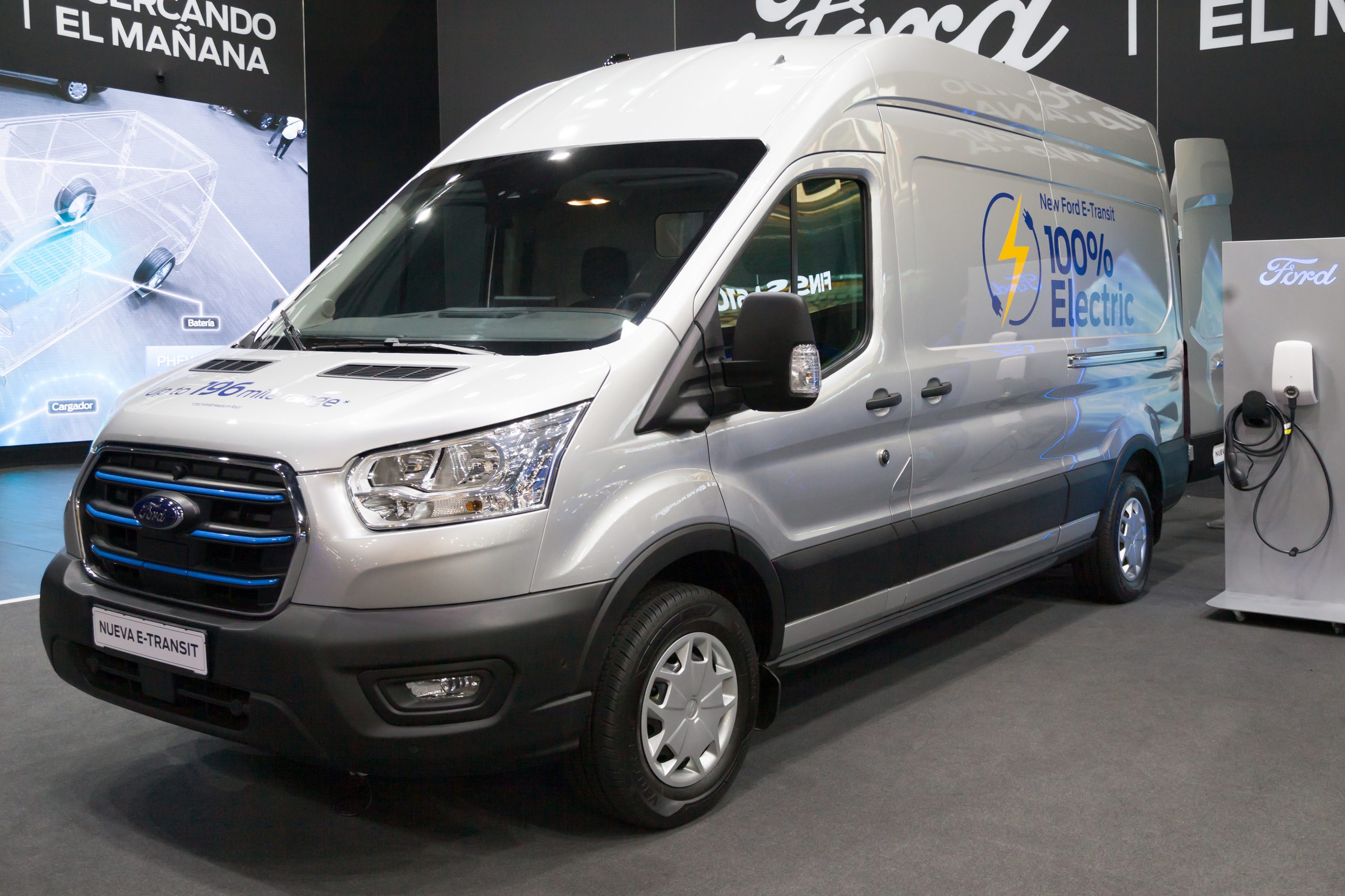 A silver Ford E-Transit van on display in a show room