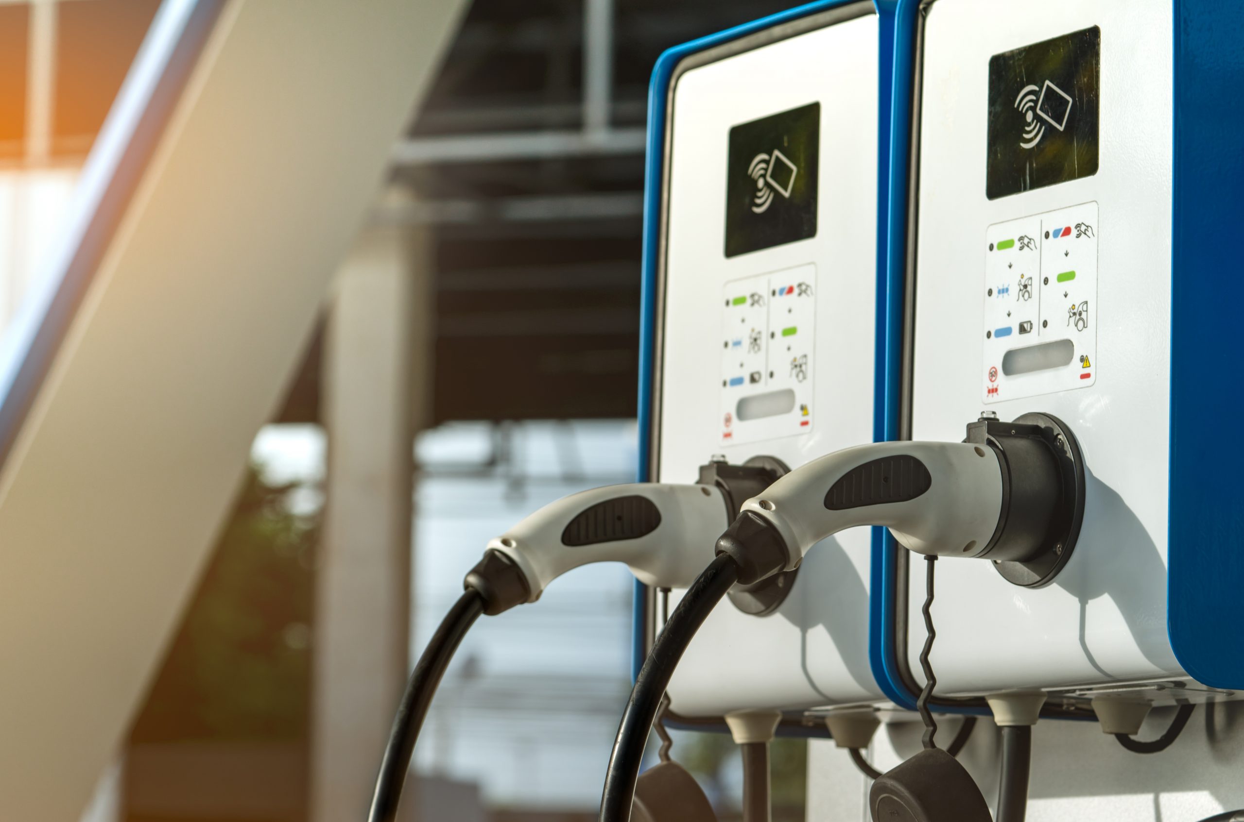 Electric car charging station. Plug for vehicle with electric motor. Coin-operated charging station. Clean energy power. Commercial charging station. Charging point. Infrastructure policy.