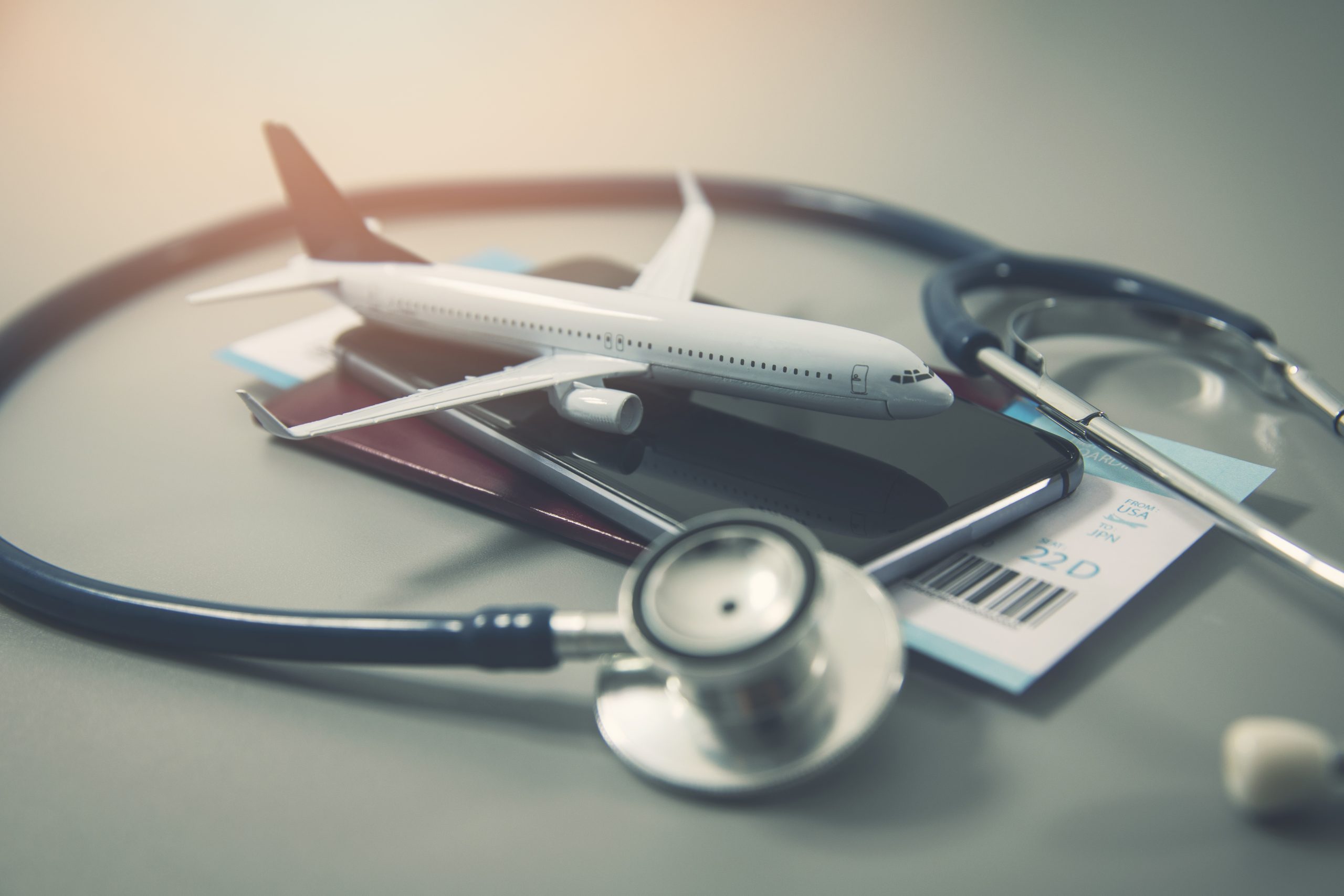 Travel documents with a stethoscope  and a model plane