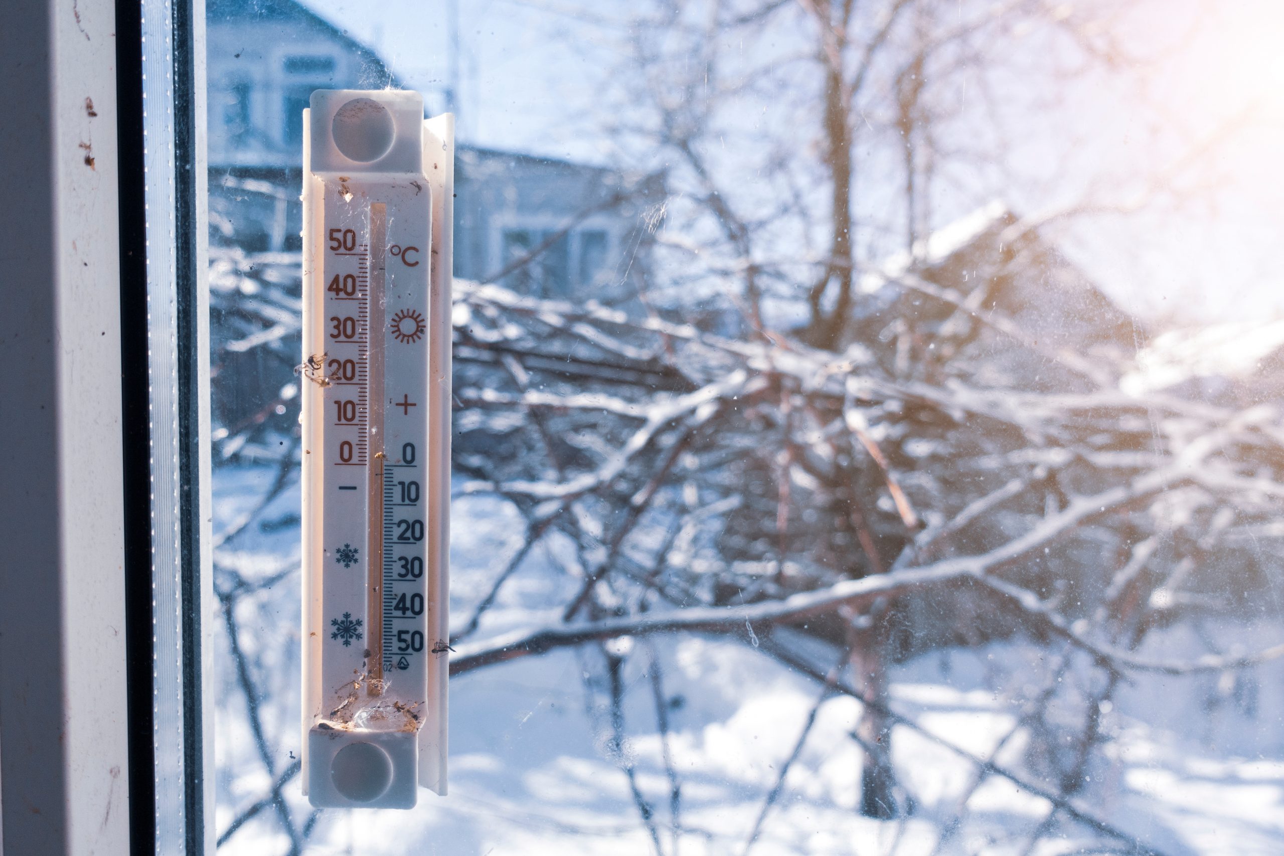 Thermometer outside the window in winter