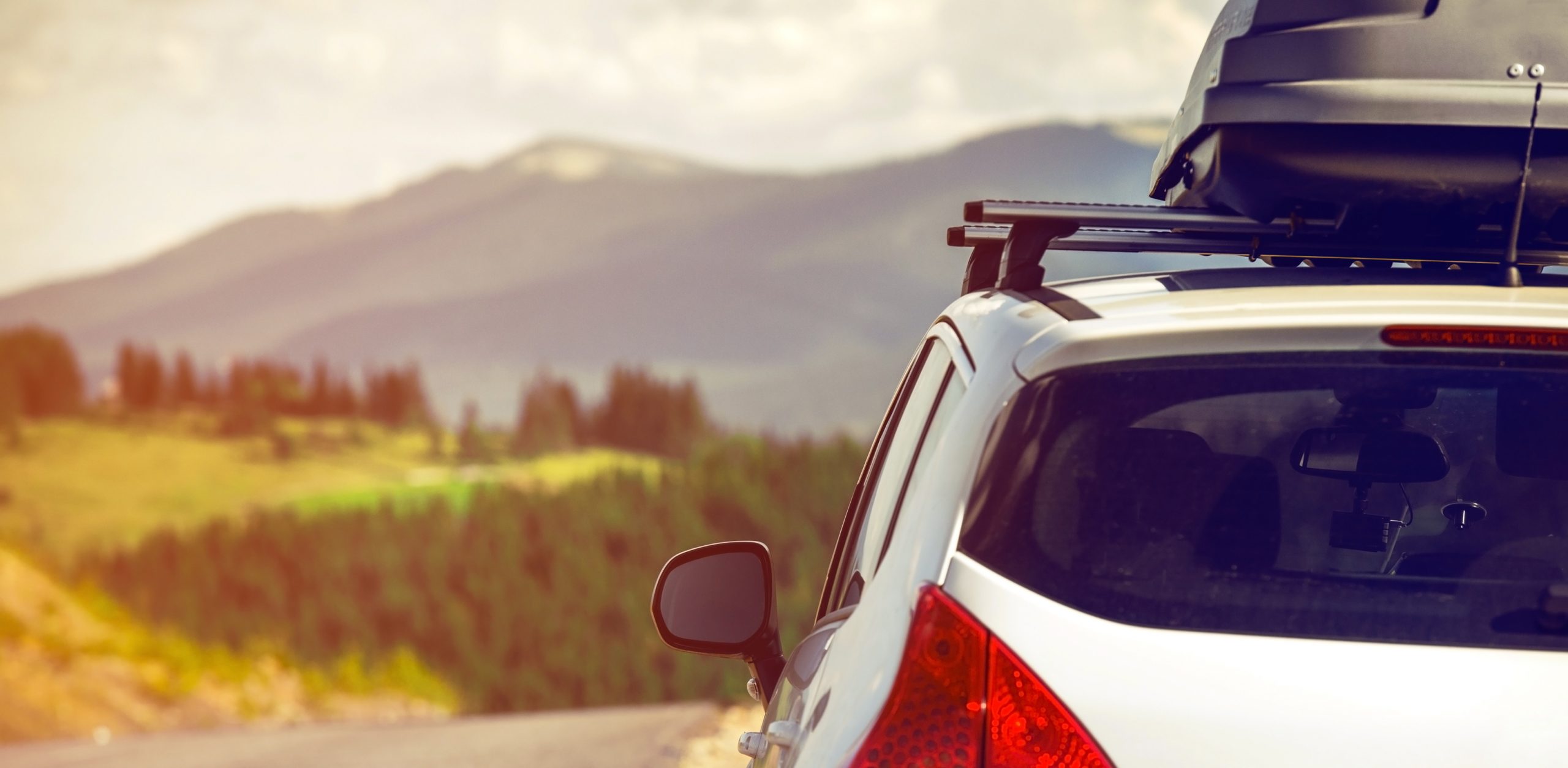 car for traveling with a roof rack on a mountain road