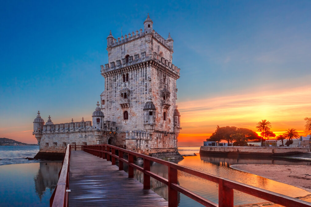 The Belem waterfront tower in Lisbon with the sunset behind it.