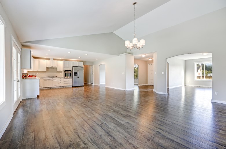 A house with no furniture, a wooden floor and white walls