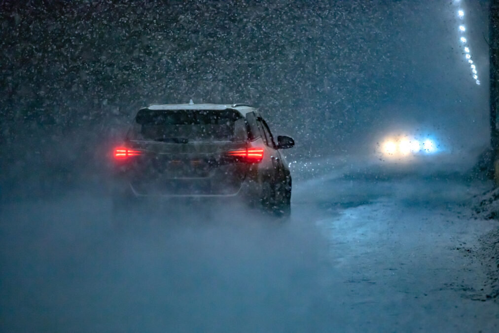 Rear of car driving through unexpected snow storm