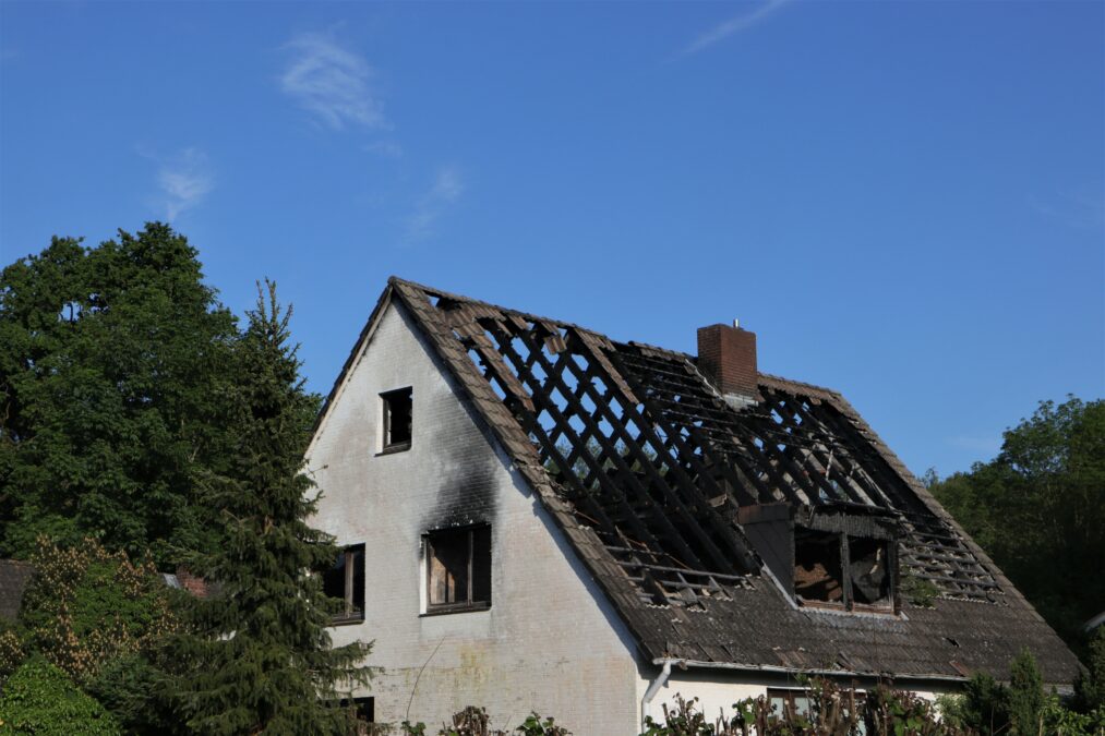 Burnt out damaged house roof