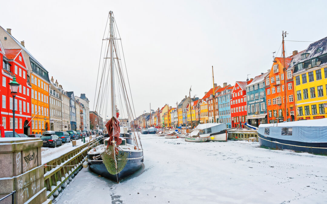 Copenhagen, Denmark - January 5, 2011: Nyhavn (New Harbor)in winter. It is waterfront, canal, entertainment district in Copenhagen in Denmark. It is lined by colorful houses, bars, cafes, wooden ships