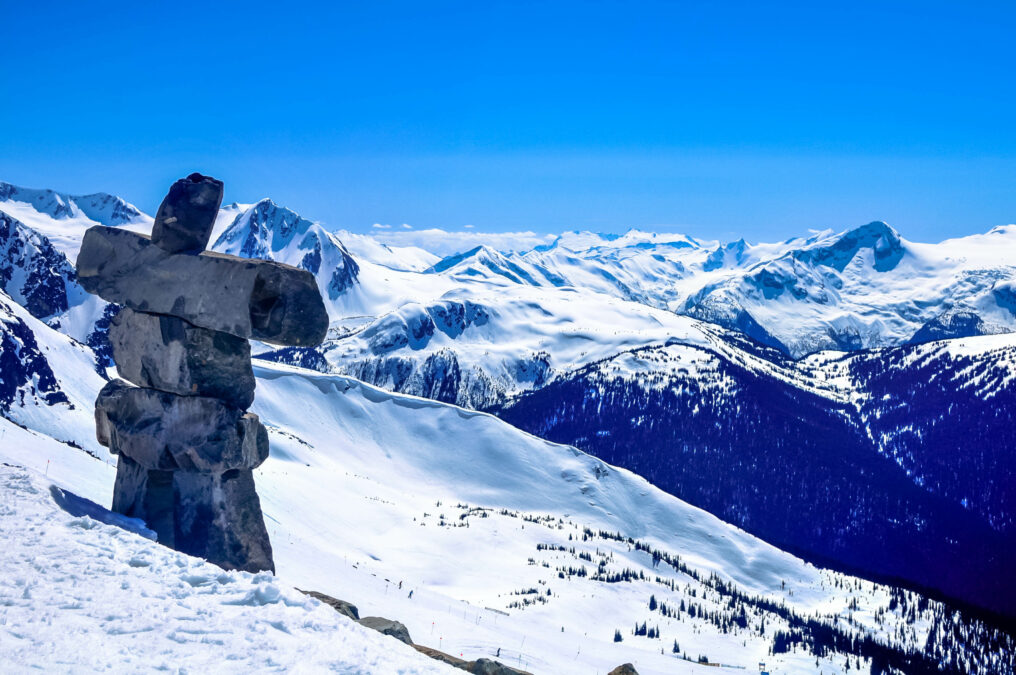 Whistler Mountain Inukshuk statue, overlooking a snowy Whistler.