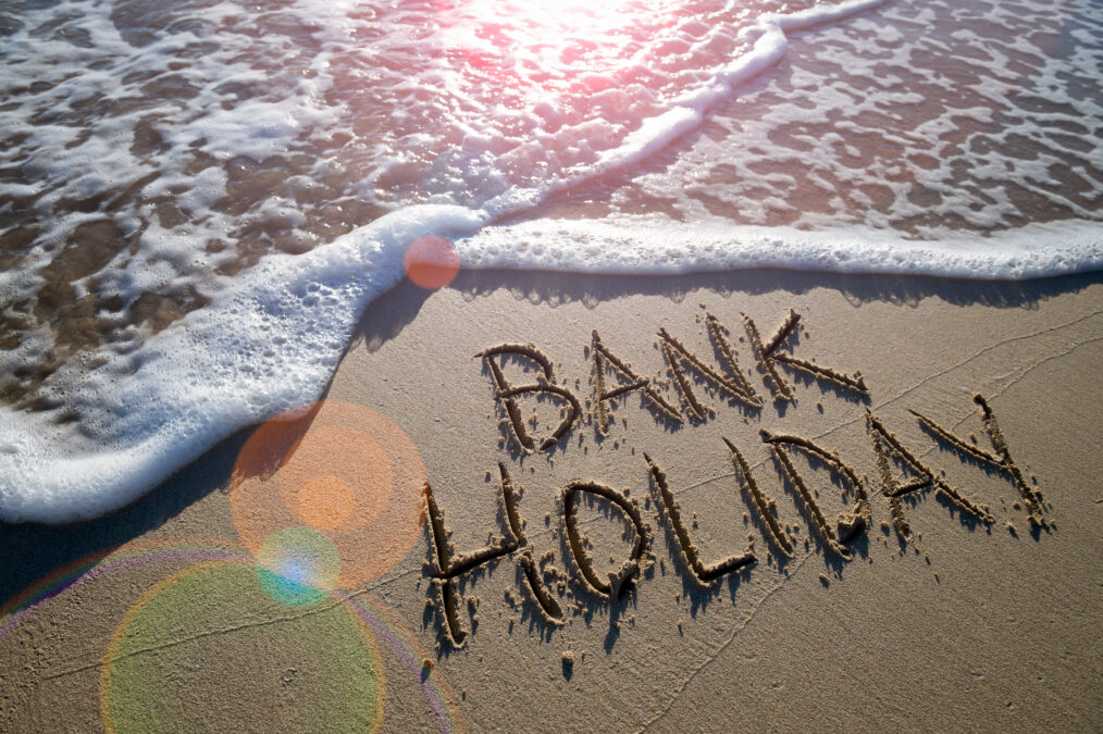 'Bank Holiday' written in the sand