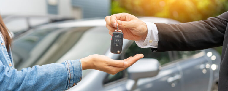Dealership handing over car keys to new owner